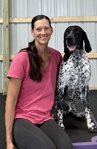 Dog trainer sitting with dog